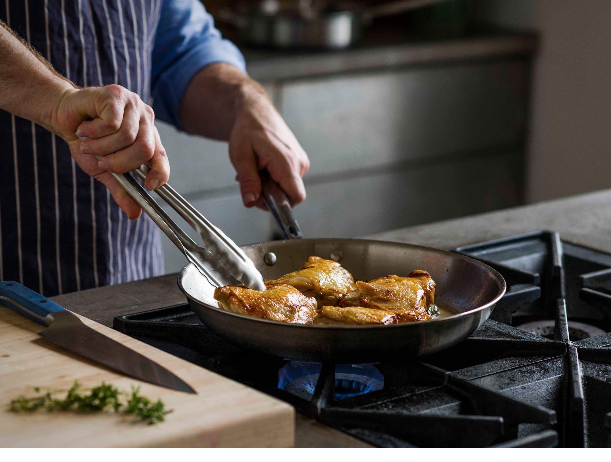 {{blue,black,gray}} Chopping thyme and searing chicken thighs to a nice, even golden brown with the Misen Chef's Knife + Skillet bundle.
