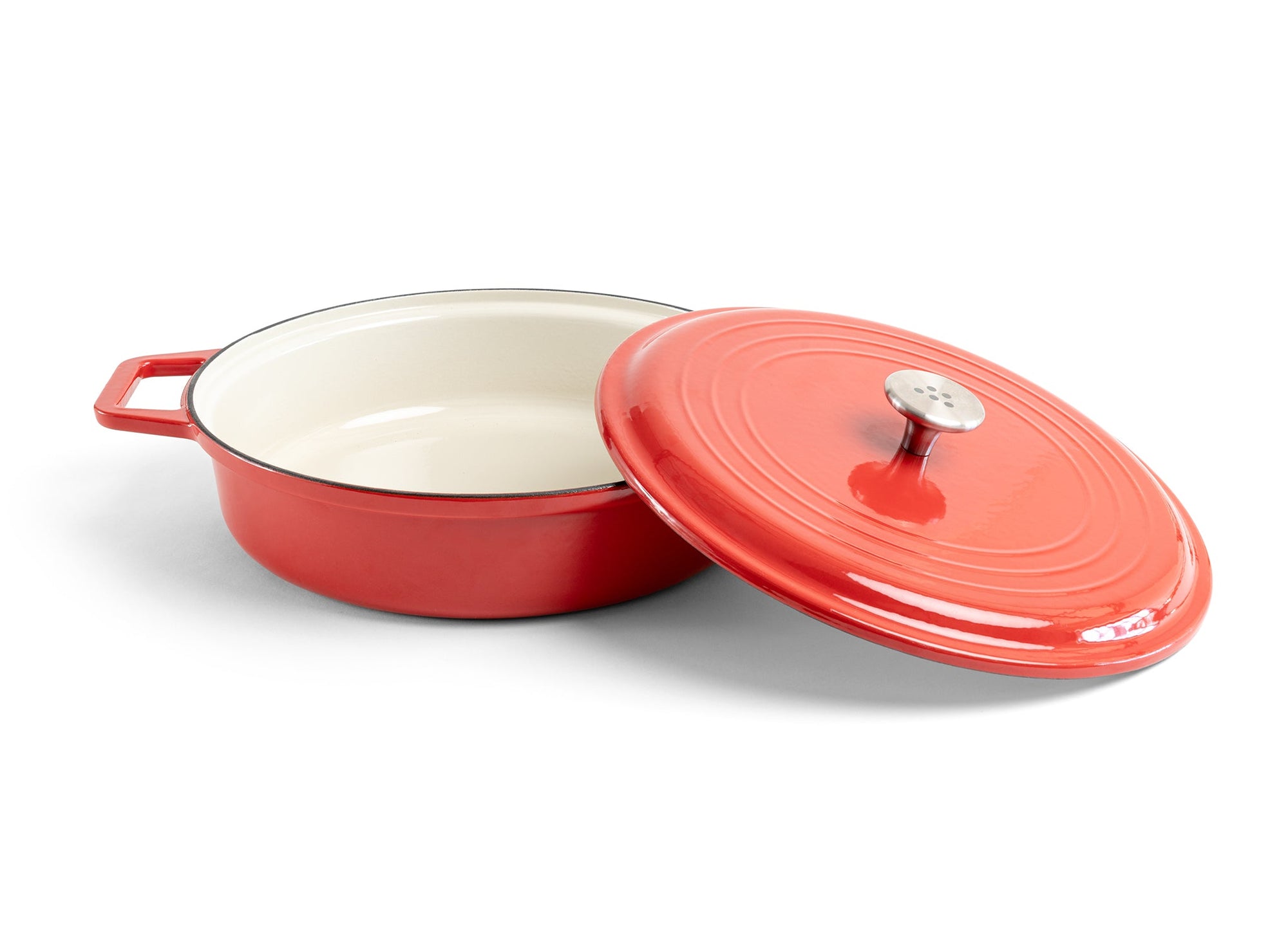 {{red}} A red Misen Enameled Cast Iron Braiser with knob-handle lid removed and resting against the pan’s side.