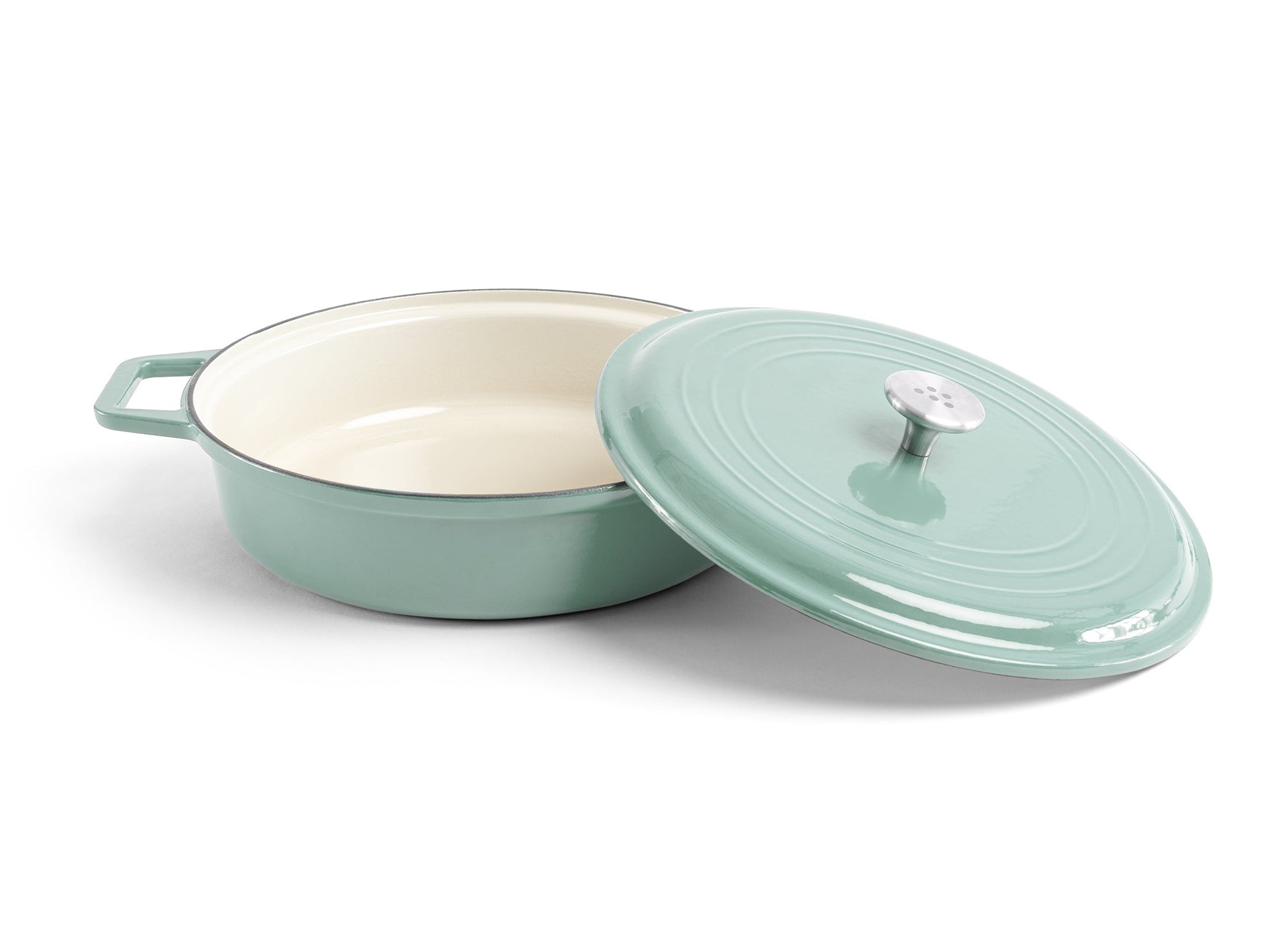 {{green}} A green Misen Enameled Cast Iron Braiser with knob-handle lid removed and resting against the pan’s side.