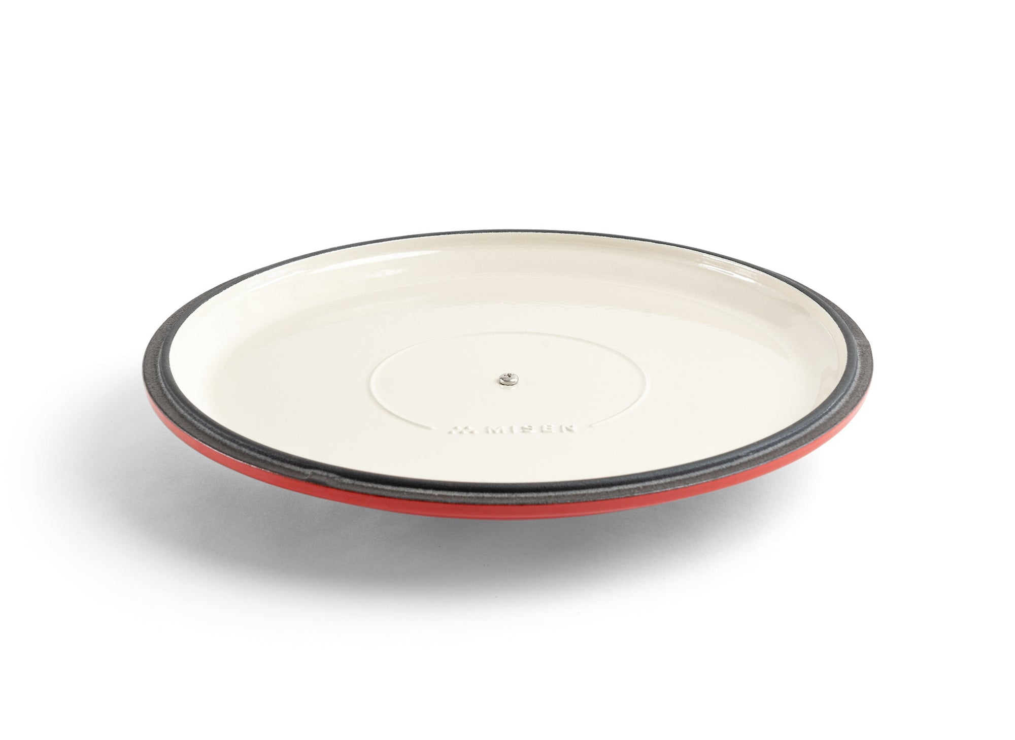 {{red}} An upside-down red Misen Enameled Cast Iron Braiser lid, with the Misen logo visible on its cream-white interior.