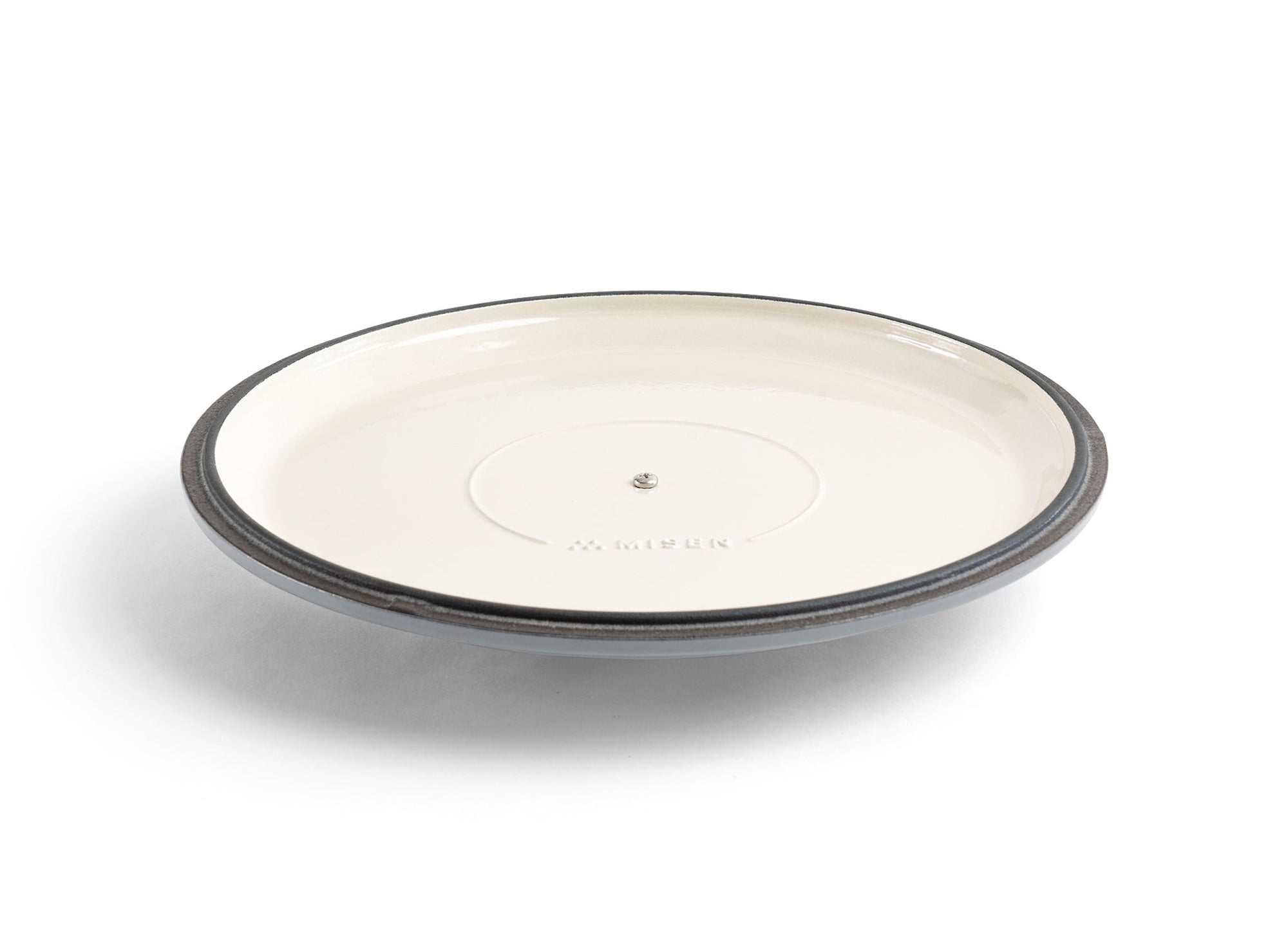 {{gray}} An upside-down grey Misen Enameled Cast Iron Braiser lid, with the Misen logo visible on its cream-white interior.