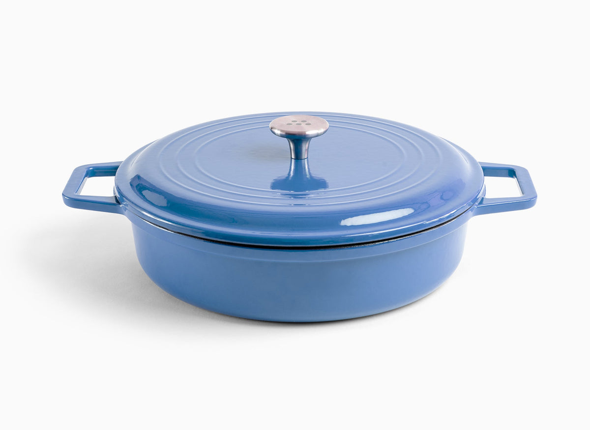 A blue Misen Enameled Cast Iron Braiser with knob-handle lid. Misen logo is visible on the lid’s central handle.