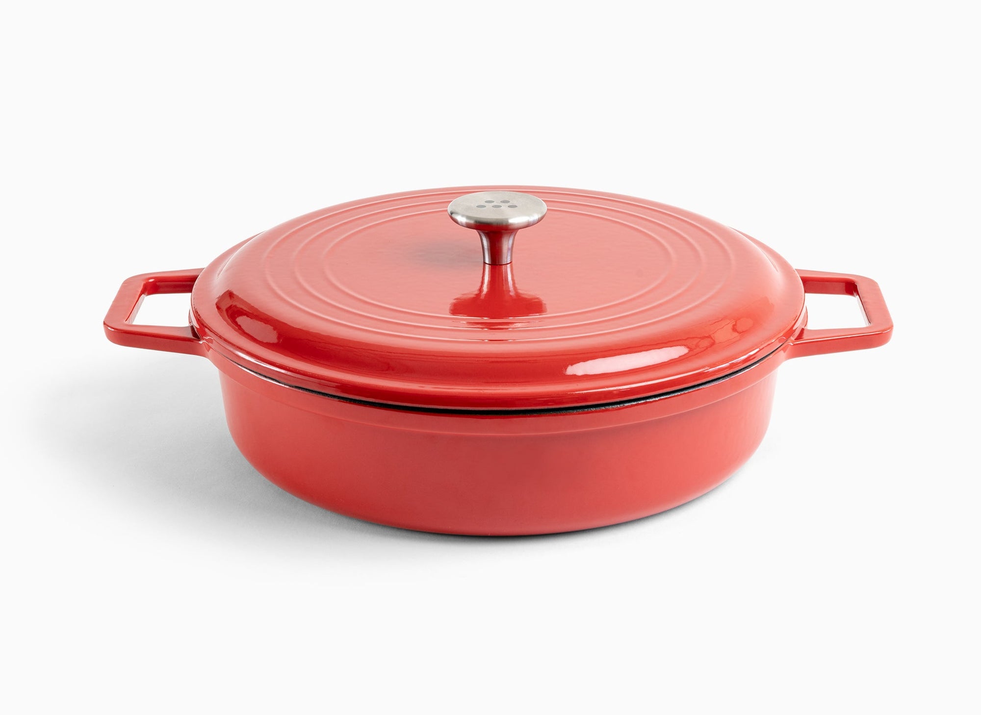 A red Misen Enameled Cast Iron Braiser with knob-handle lid. Misen logo is visible on the lid’s central handle.