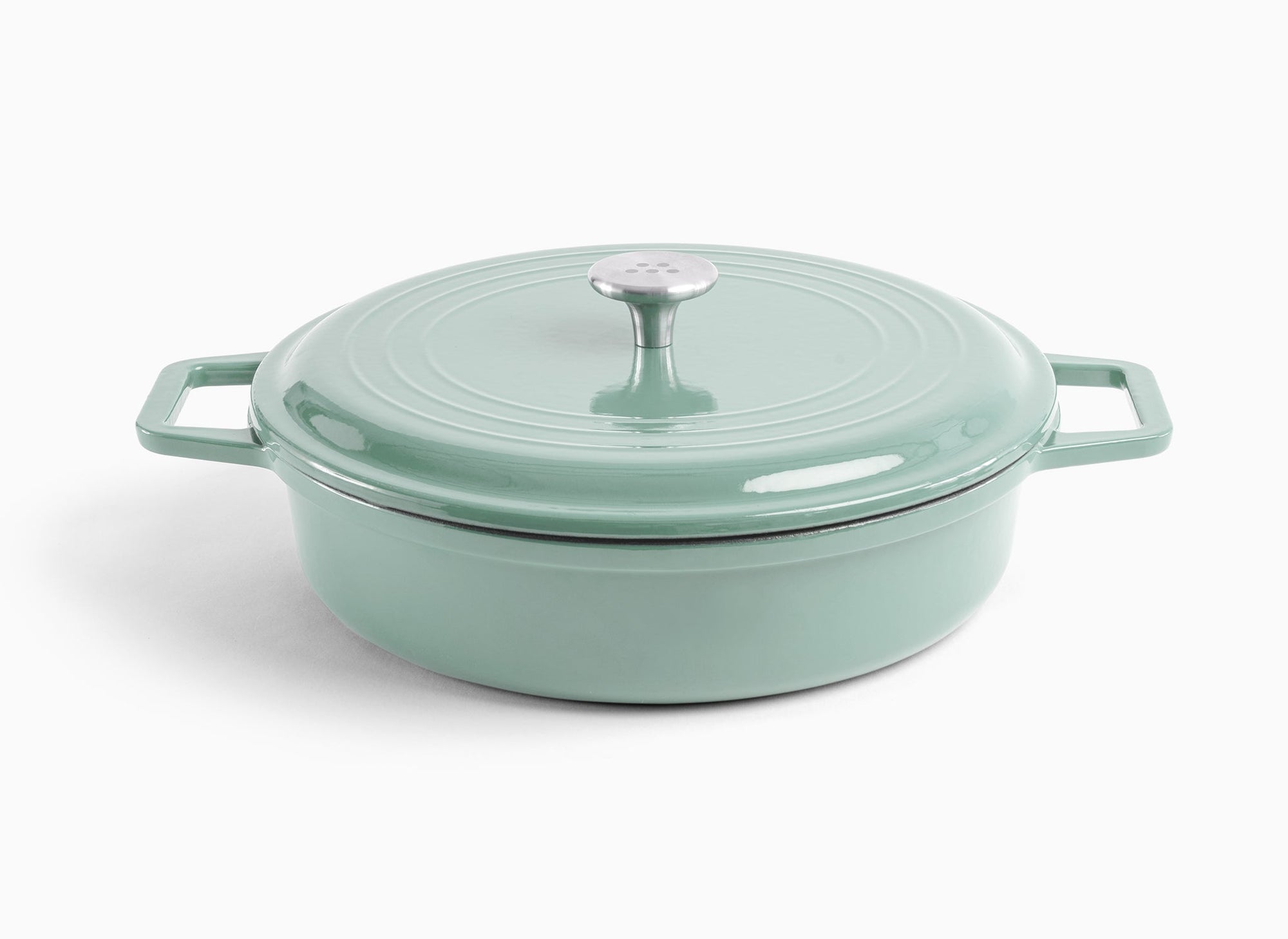 A green Misen Enameled Cast Iron Braiser with knob-handle lid. Misen logo is visible on the lid’s central handle.