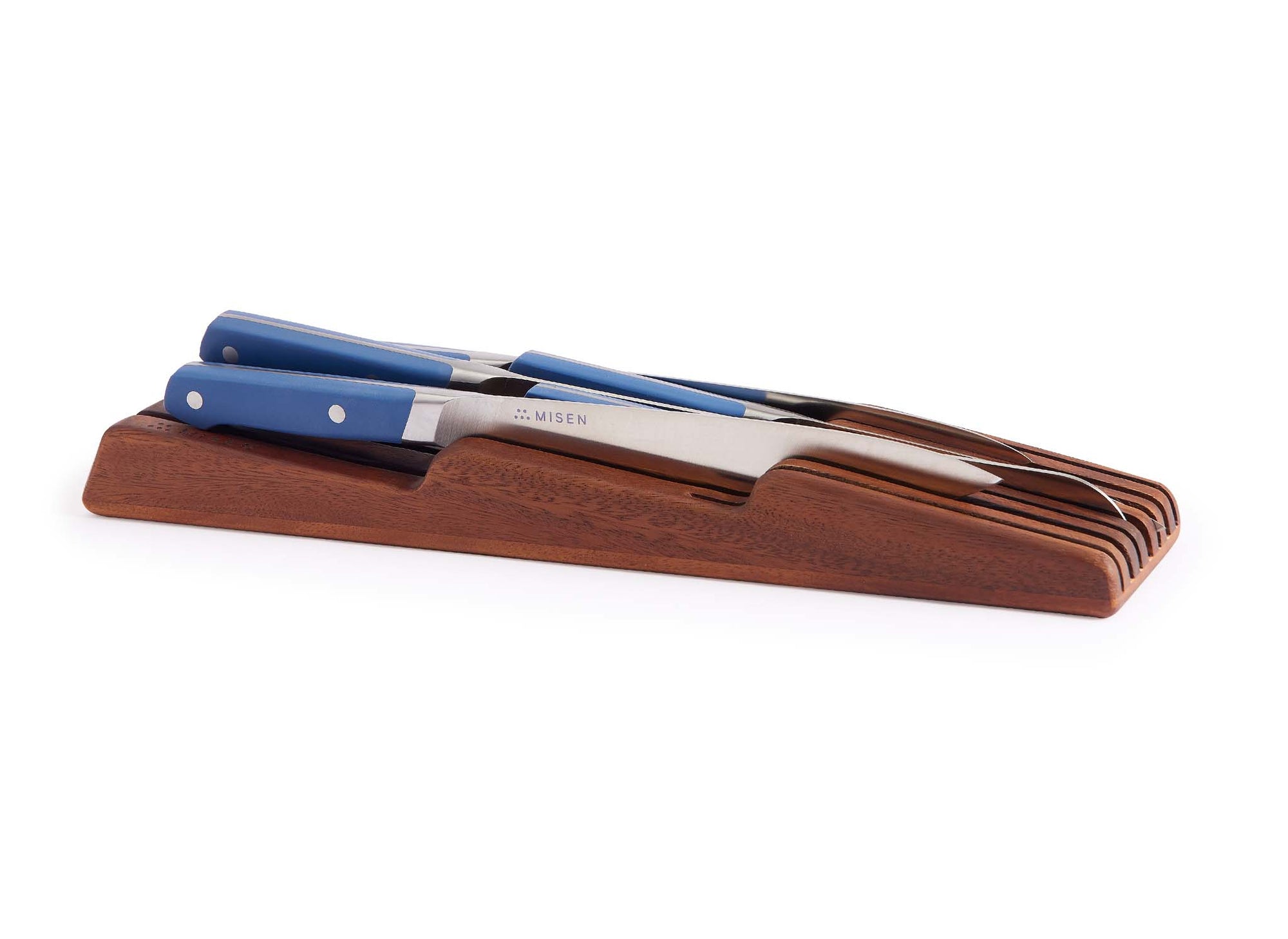 {{walnut}} Misen In-Drawer Knife Storage in Walnut, seen from a slight angle with Misen Chef’s, Serrated, and Paring Knives visible.
