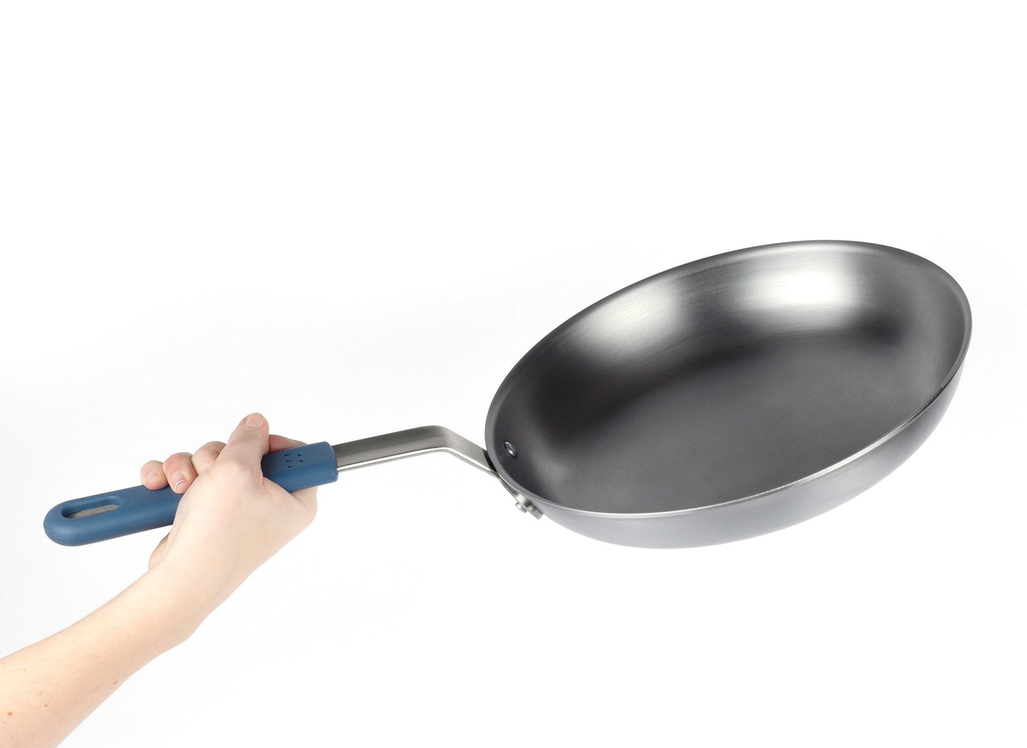 {{complete}} A hand holds a Misen Carbon Steel Pan with blue removable silicone handle visible.