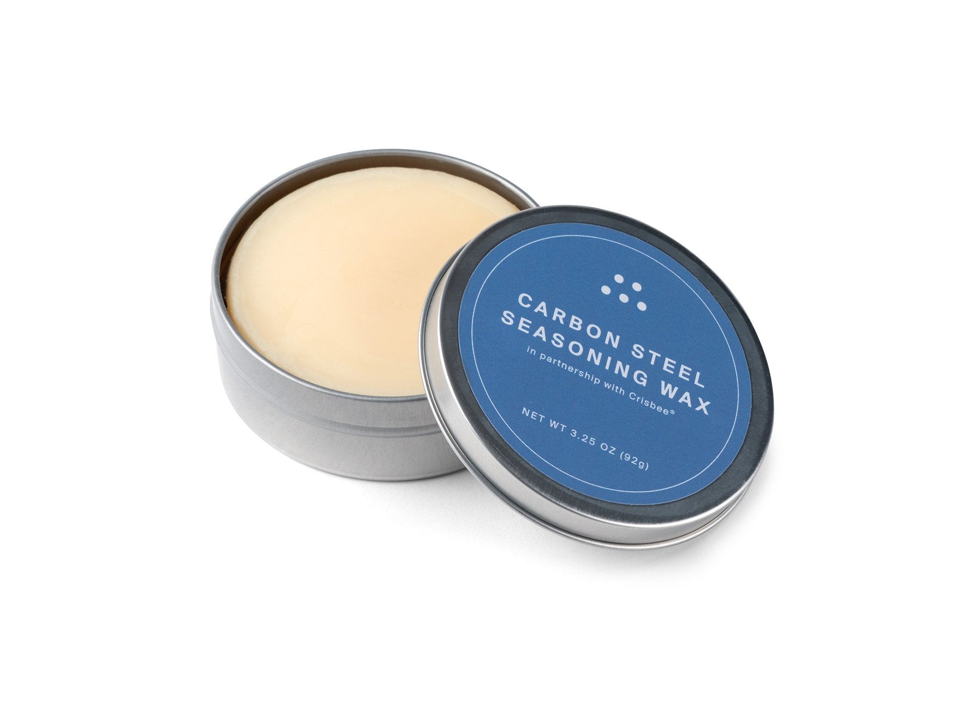 {{complete}} An open tin of Misen Carbon Steel Seasoning Wax seen from a slight angle, with blue Misen label and beige wax puck visible.
