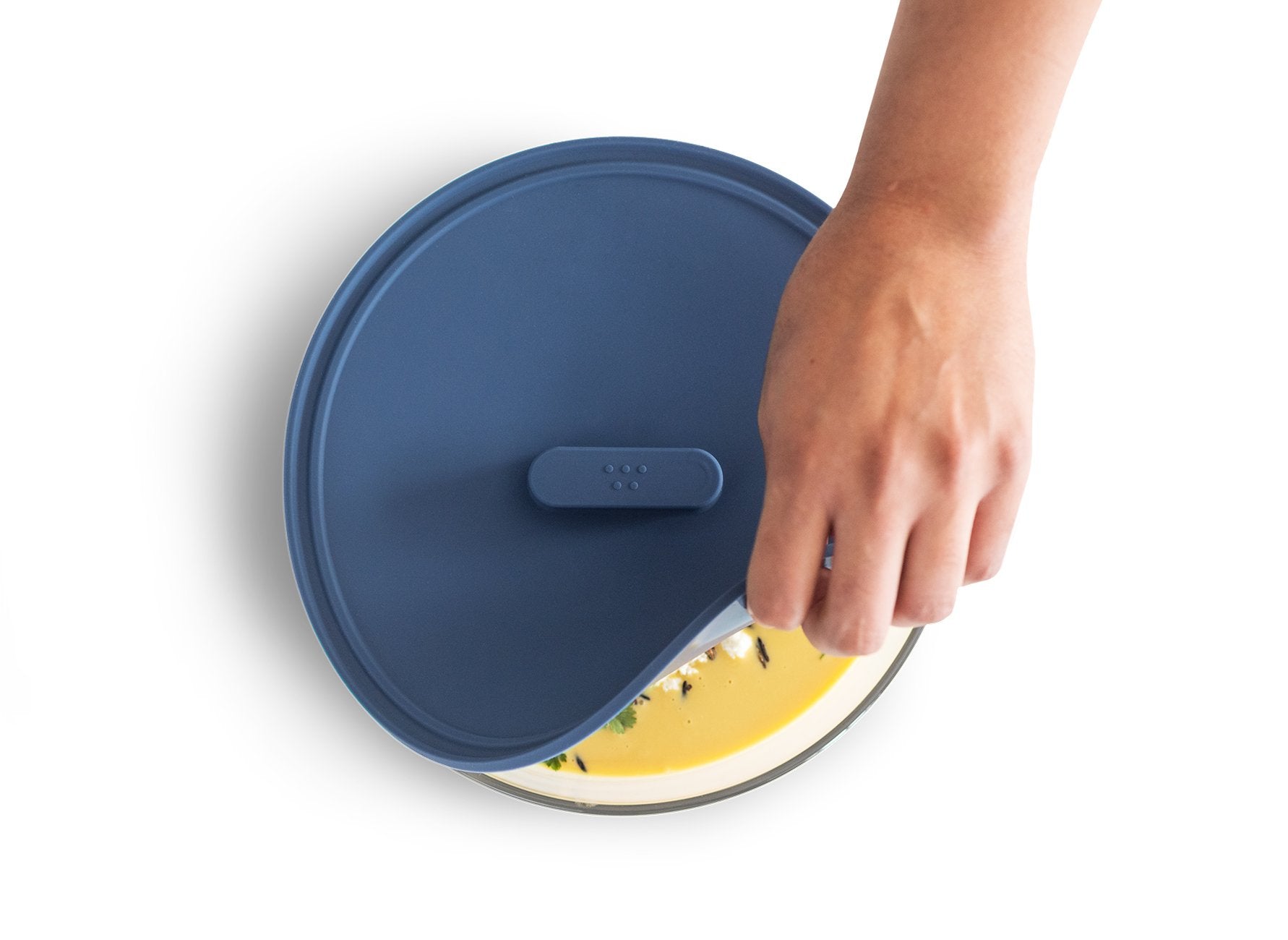 {{8-inch, 10-inch, 12-inch, 8-10-12-inch}} Peeling a Misen Universal Lid off of a bowl of creamy yellow squash soup.
