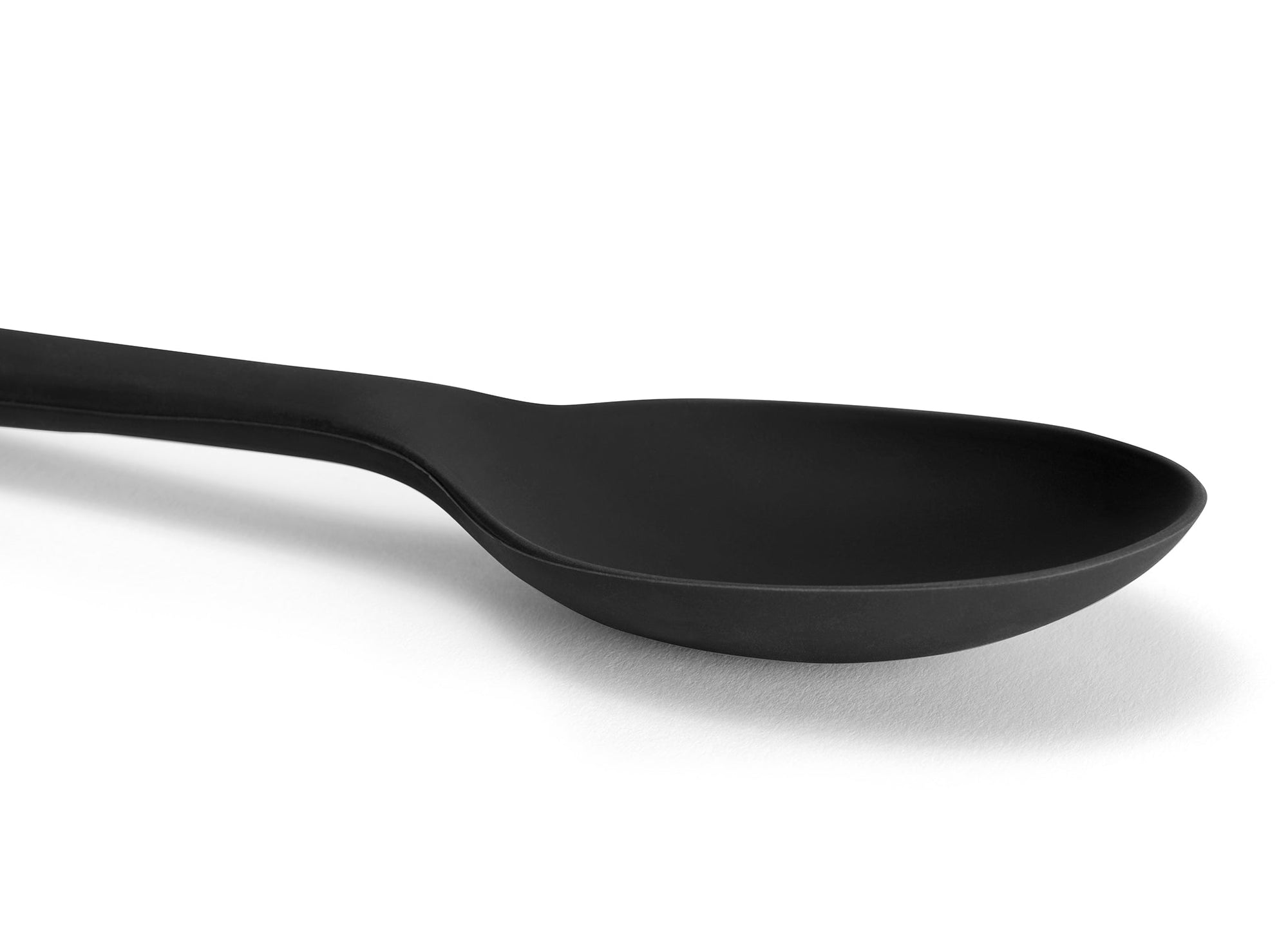 {{black}} A close view of a Black Misen Mixing Spoon’s curved head on a white background.