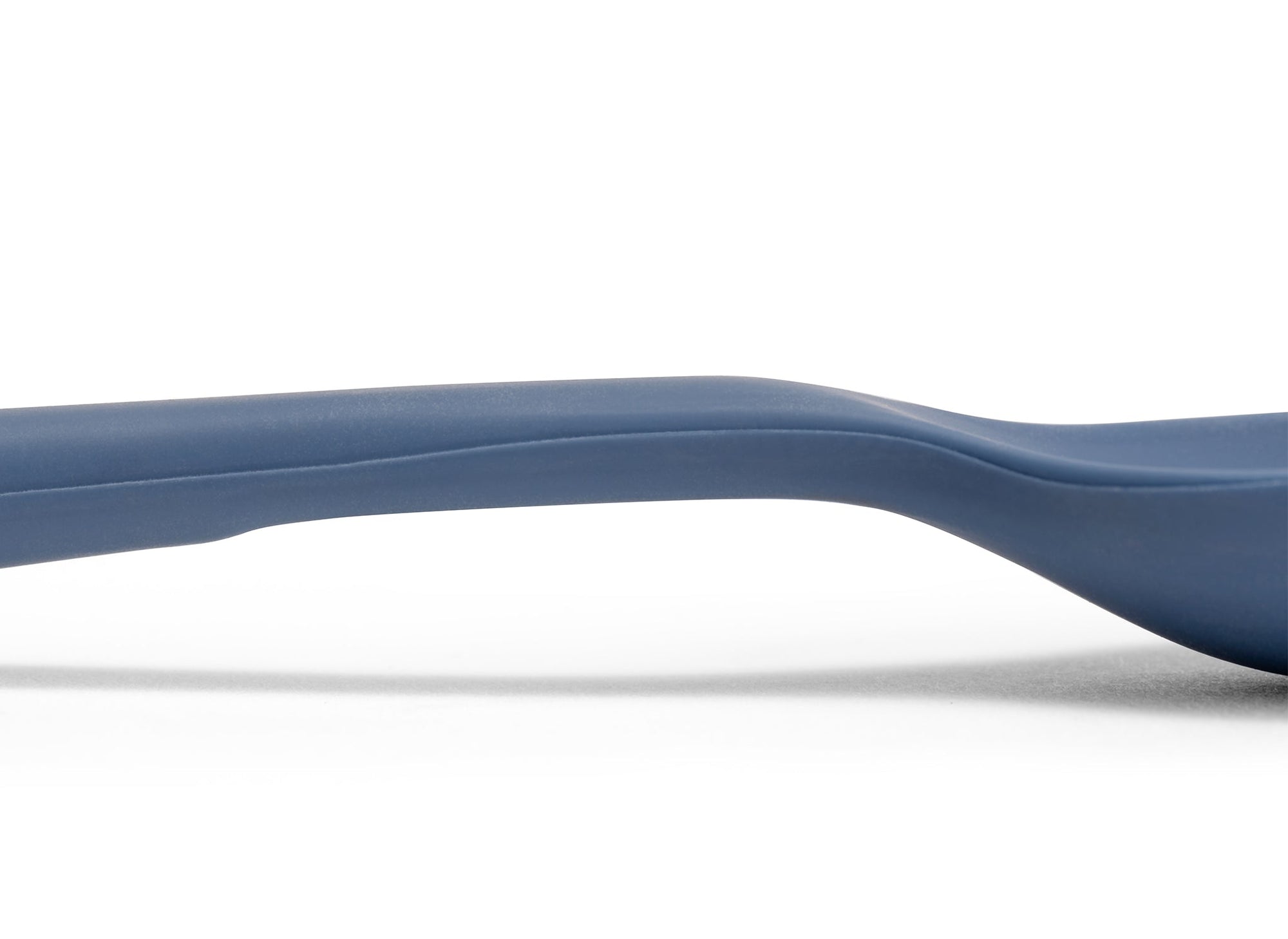 {{blue}} A close view of the area where a Blue Misen Mixing Spoon’s head meets its handle, with a flattened area visible on the bottom.