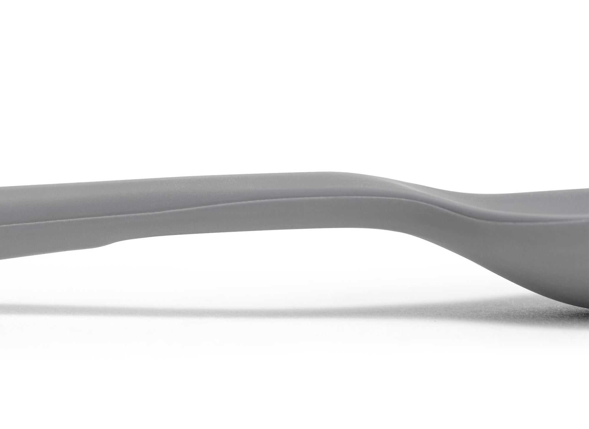 {{gray}} A close view of the area where a Grey Misen Mixing Spoon’s head meets its handle, with a flattened area visible on the bottom.