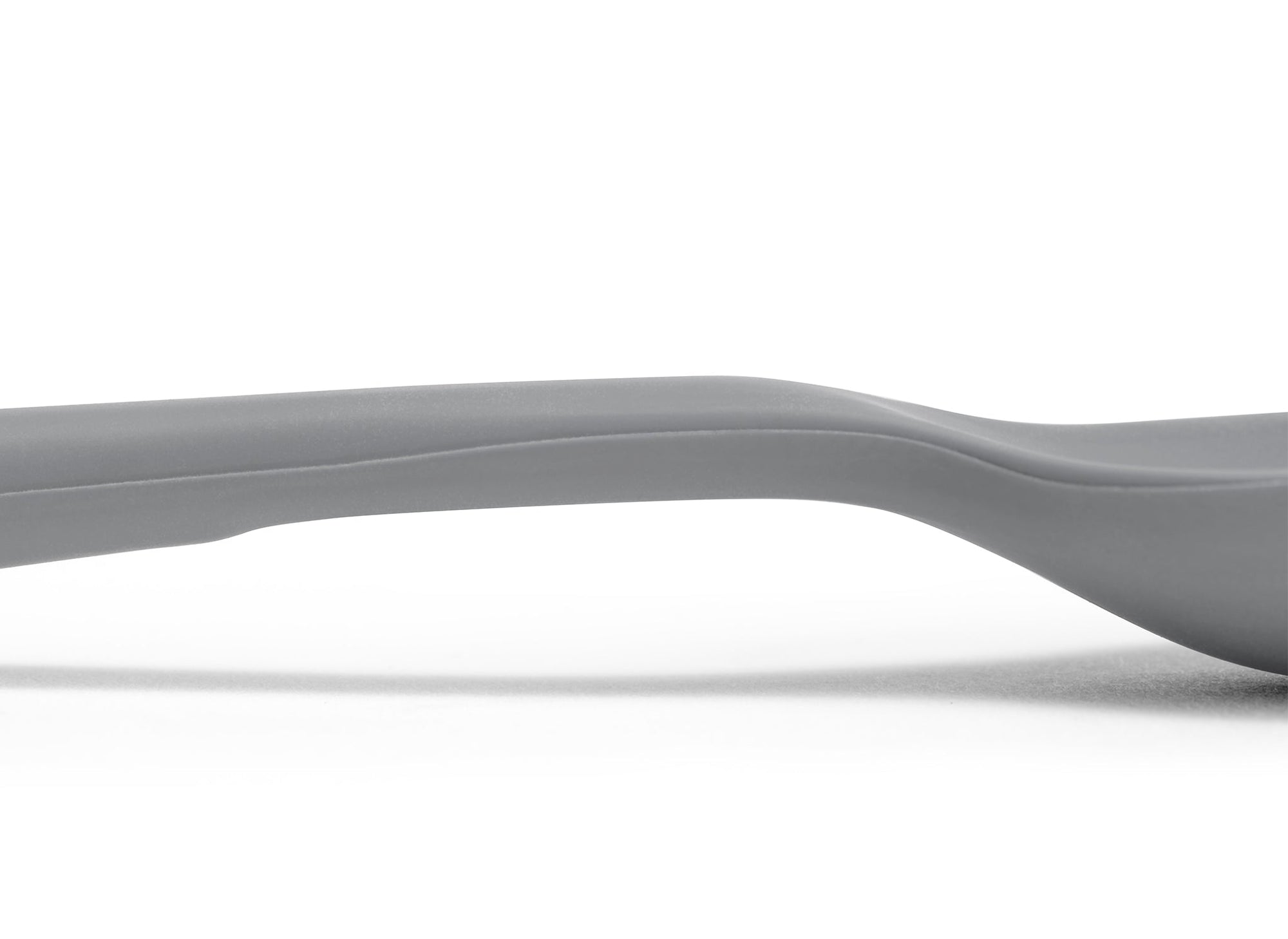 {{gray}} A close view of the area where a Grey Misen Mixing Spoon’s head meets its handle, with a flattened area visible on the bottom.