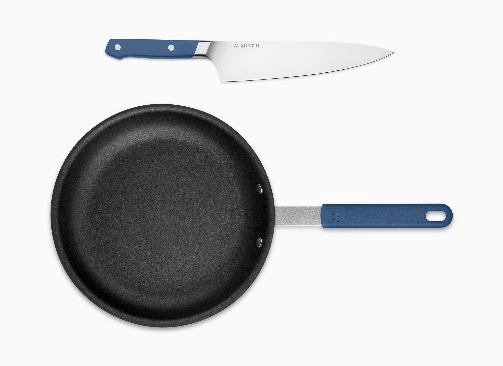 A bird’s eye view of the Misen Nonstick Pan and Misen Chef’s Knife with blue handle on a white background.
