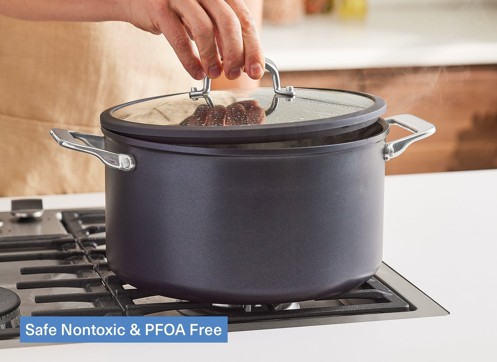 A chef places a lid atop a Misen Nonstick Stock Pot on a stovetop. A caption reads: “Safe Nontoxic & PFOA Free”