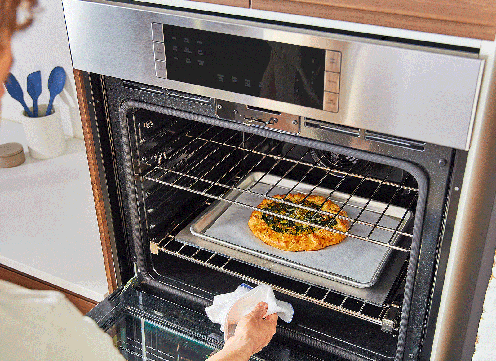 {{single, 2-pack, 4-pack}} A chef removes a golden-brown vegetable galette—well-cooked after baking atop two Misen Oven Steels—from an oven.