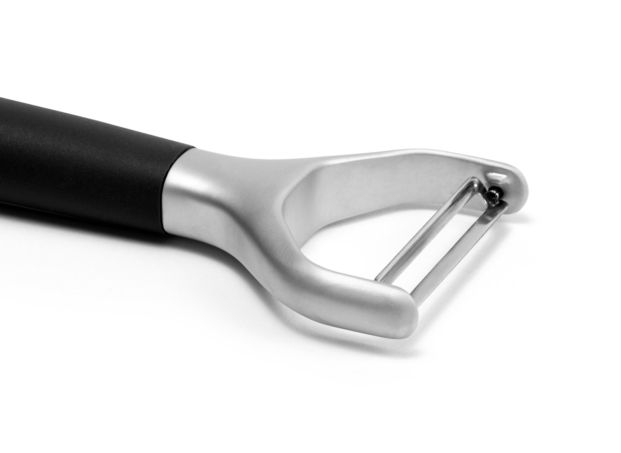 {{black}} Close view of a Black Misen Peeler’s metal head and steel blade on a white background.