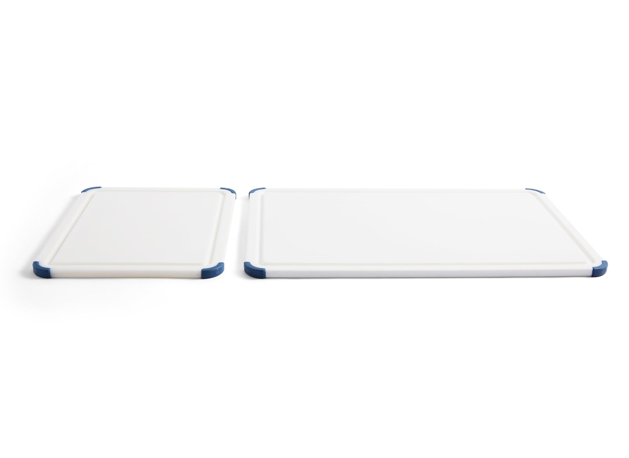{{2-piece-set}} A 2-Piece Misen Plastic Cutting Board Set laying face-up side-by-side, with juice grooves and corner grips visible.