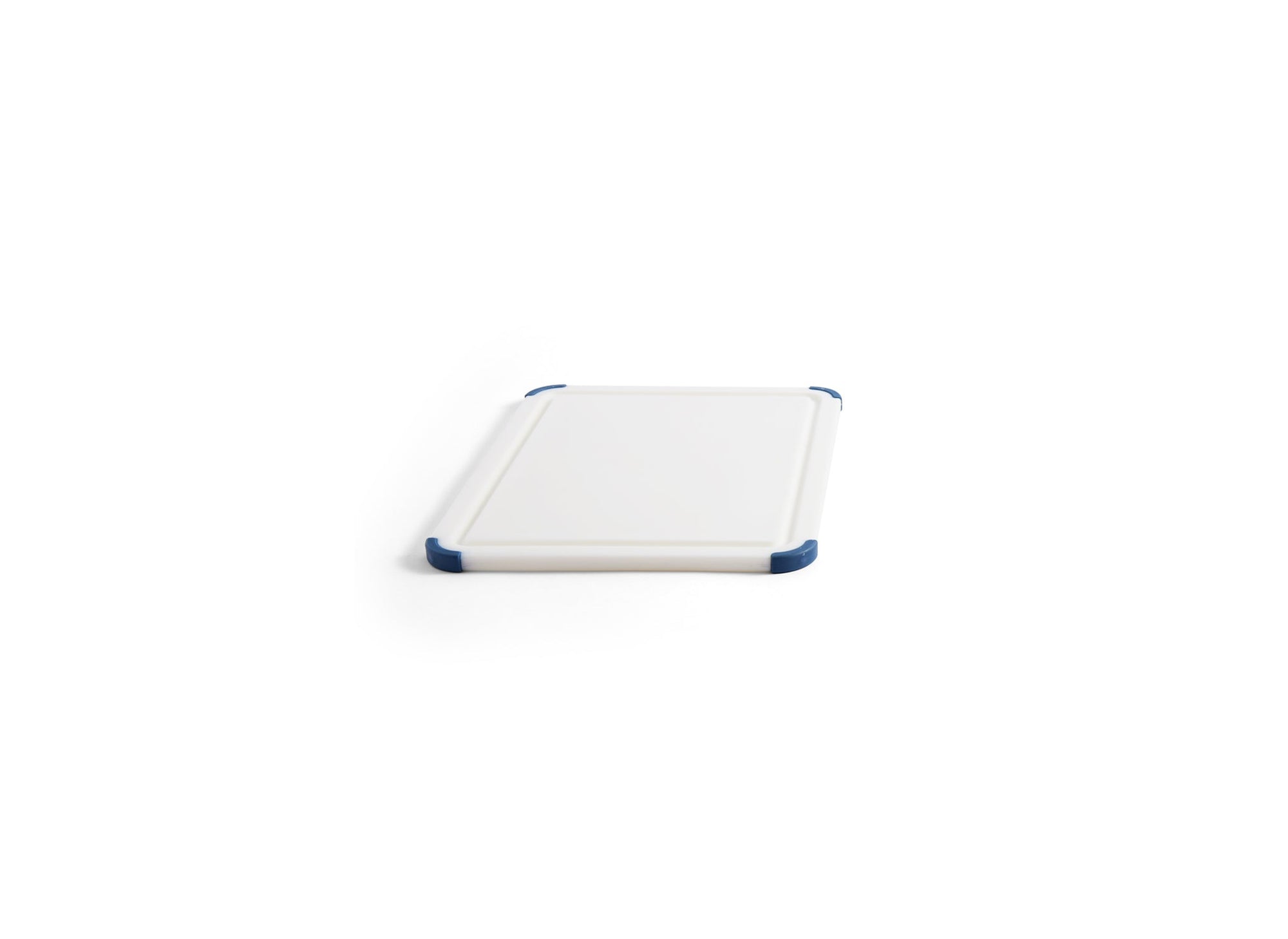 {{small}} A small Misen Plastic Cutting Board seen from an angle, with juice groove and blue corner grips visible.