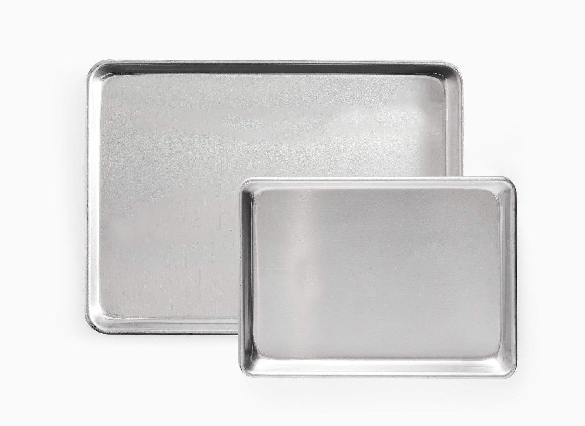 A bird’s eye view of the Misen Small Sheet Pan Set, which shows one Half Sheet Pan beneath one Quarter Sheet Pan.