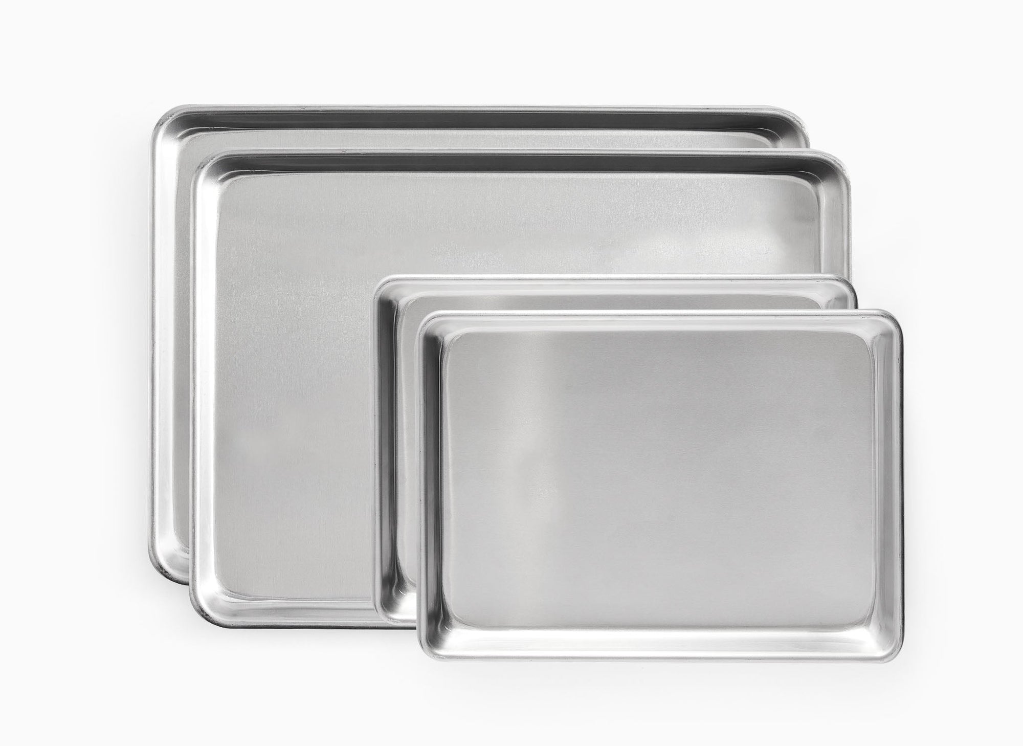 A bird’s eye view of the Misen Large Sheet Pan Set, which shows two Half Sheet Pans beneath two Quarter Sheet Pans.