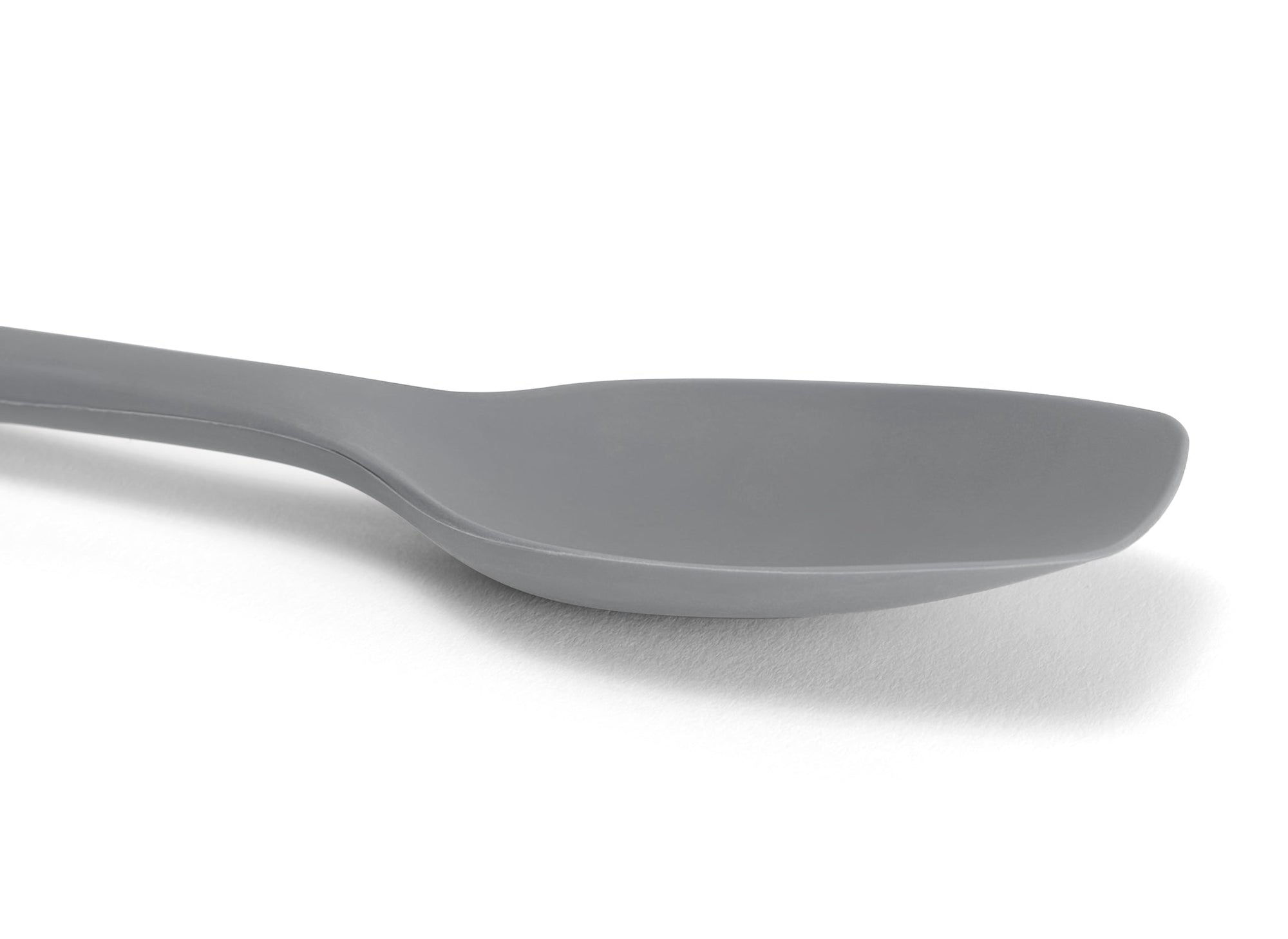 {{gray}} Close view of a Grey Misen Spoontula’s silicone head, deeply curved like a spoon with a spatula’s flexible rounded corners.